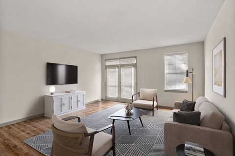 a living room with a couch and a chair and a tv
